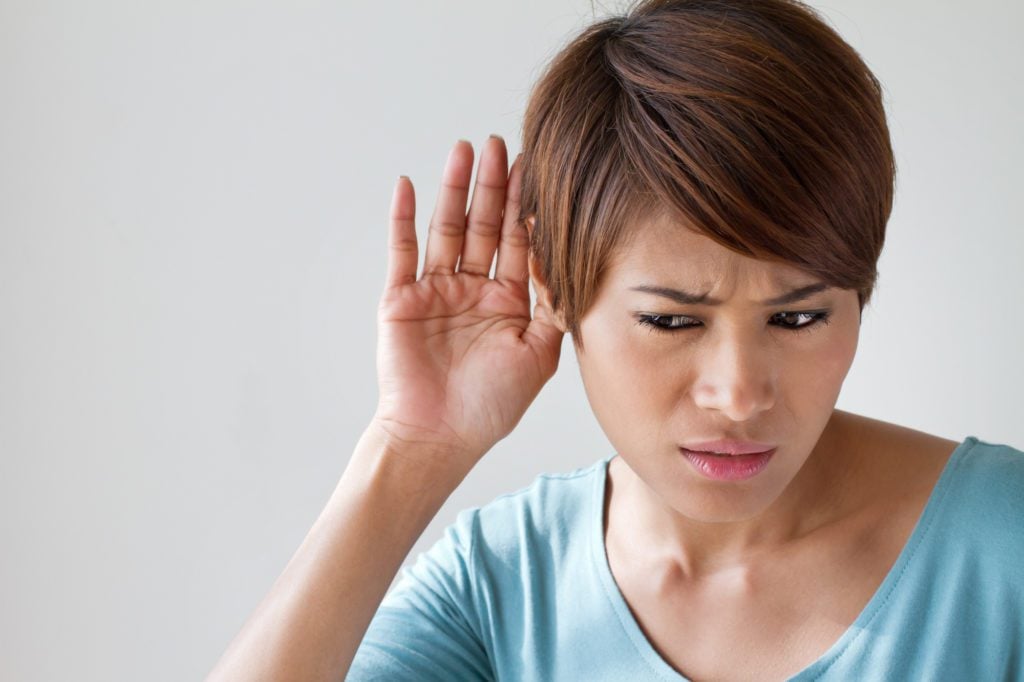 Woman with her hand to her ear