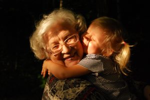 Little girl hugging an elderly woman