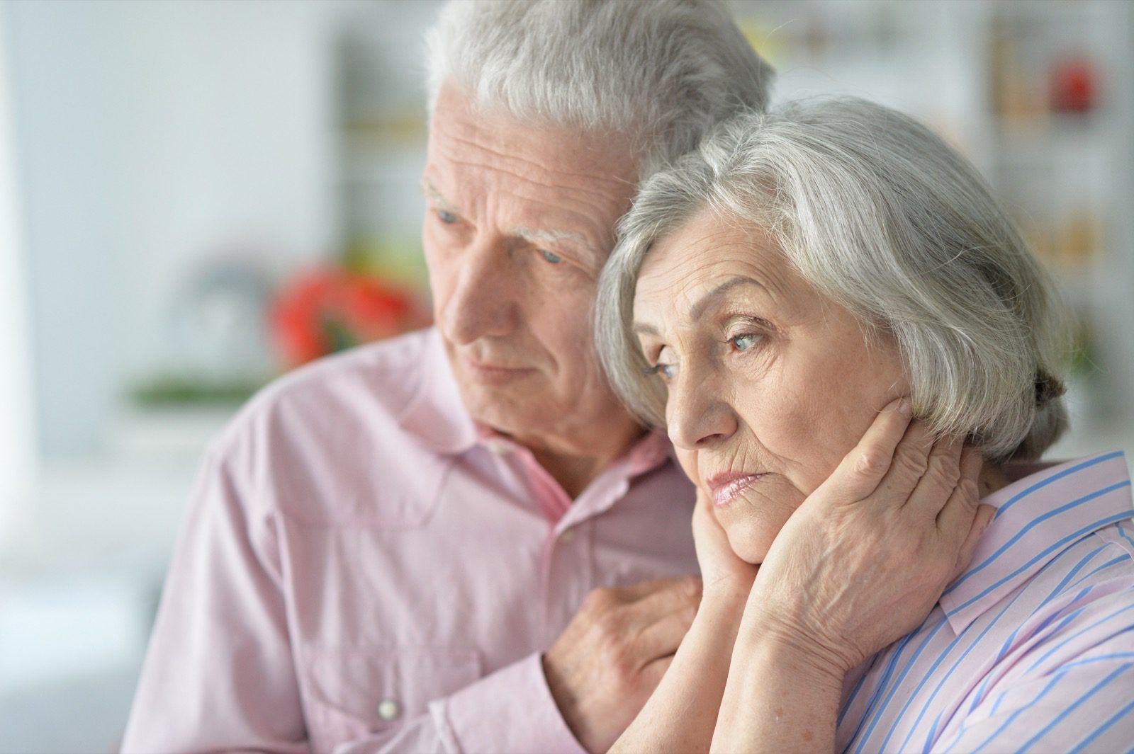 Concerned elderly couple looking off into the distance