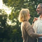 Middle-aged couple dancing outside