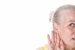 Woman with her hand to her ear