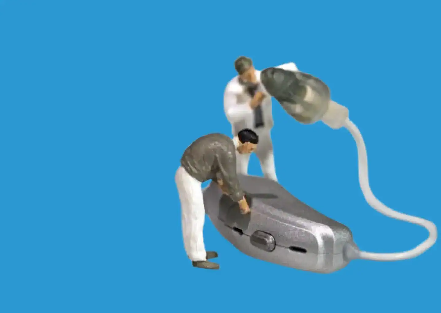 Miniature figures tuning up some hearing aids